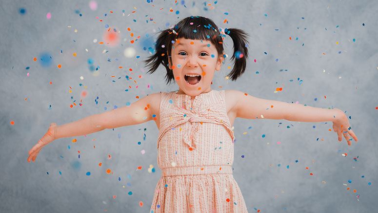 Girl spreading confetti in air