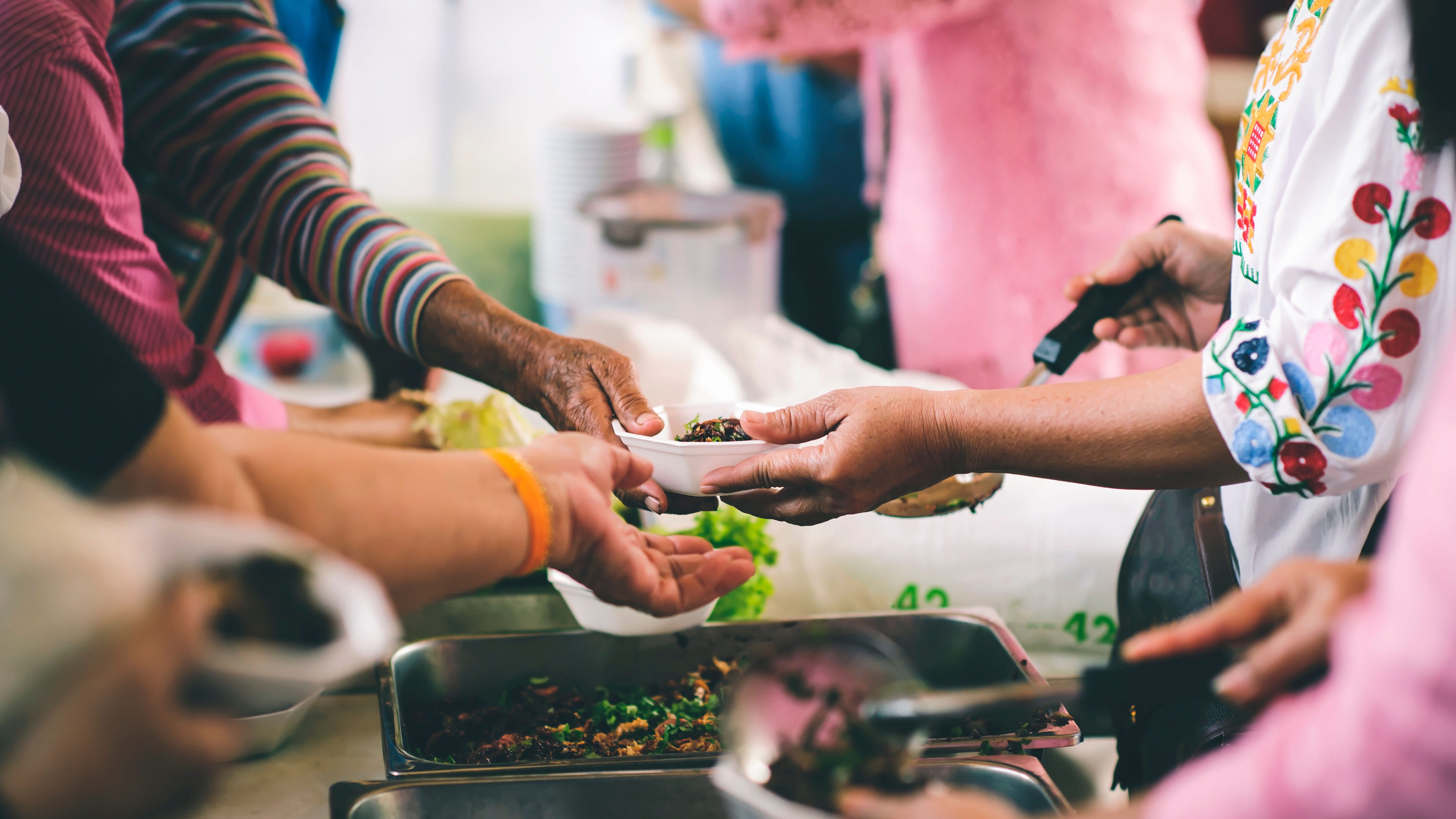 Community members donating and serving food 