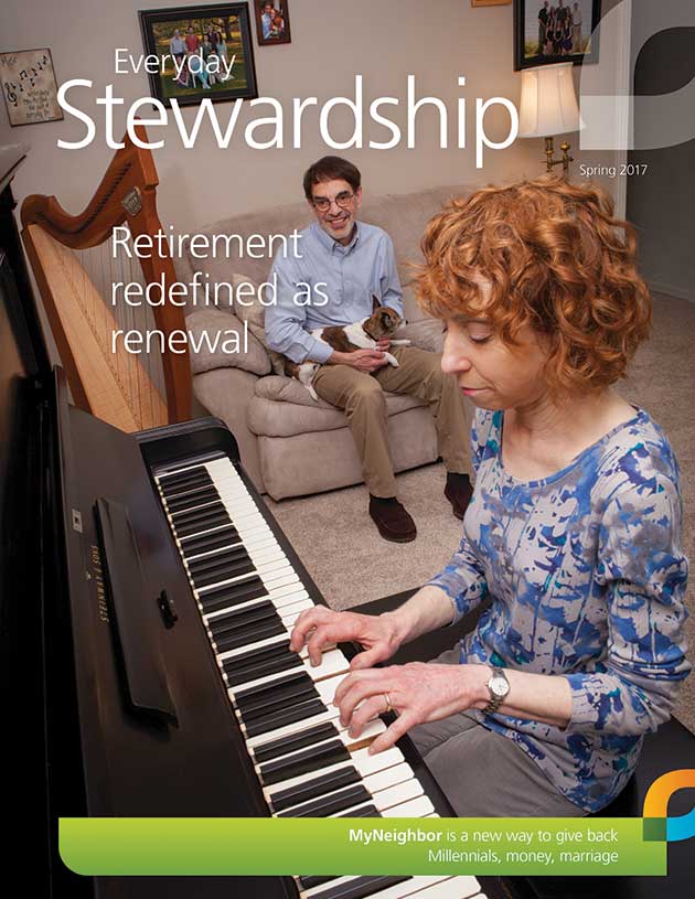 Sabrina Sigal Falls plays the piano in front of husband David Falls and dog on couch