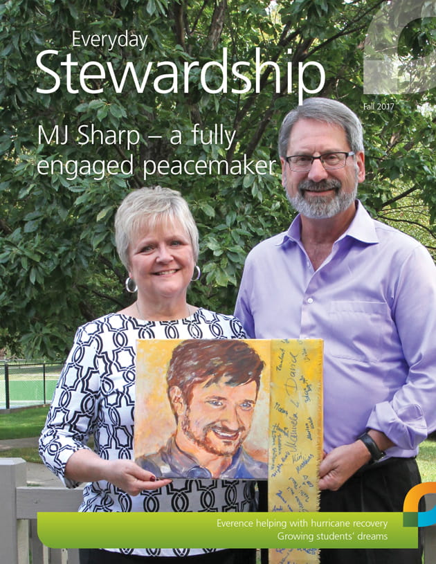 Michelle and John Sharp pose with painting of their son, Michael (MJ) Sharp