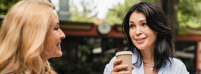 Two woman having a conversation over coffee