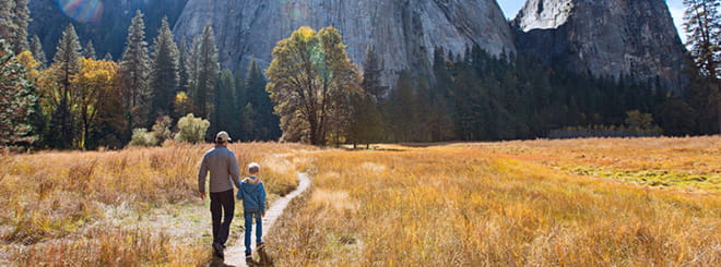 Dad and son walking into mountains