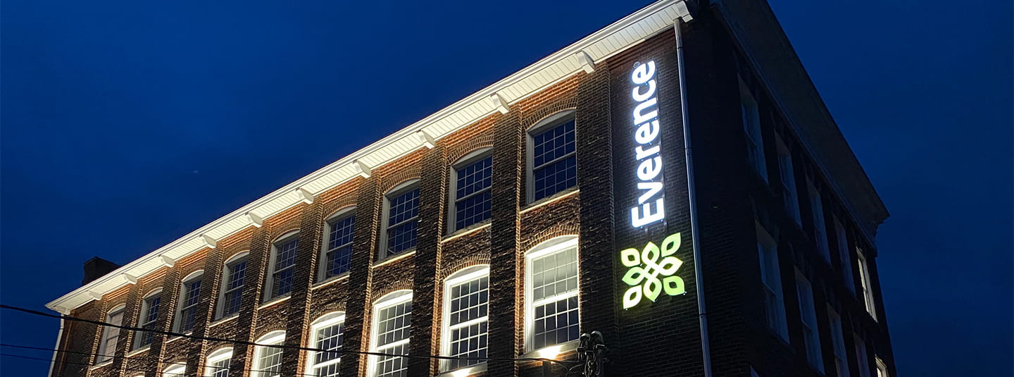 Souderton, Pennsylvania office front at night with lights at every window and lit logo | Everence Financial, faith-based financial services