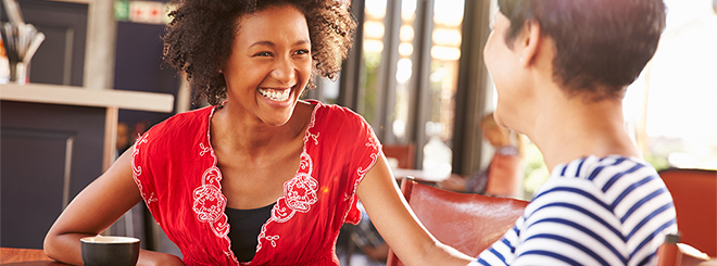 Two women talking and smiling at a table