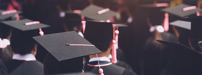 Graduates with caps in crowd