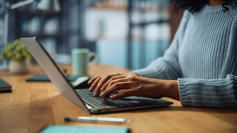 Person typing on a laptop.